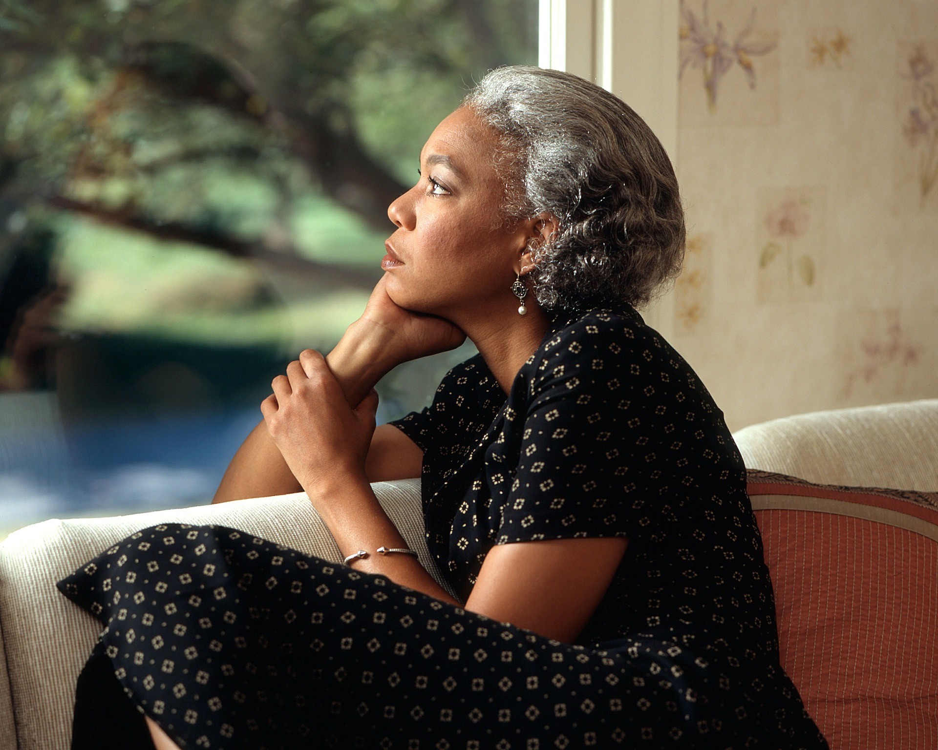 woman sitting on couch in deep thought